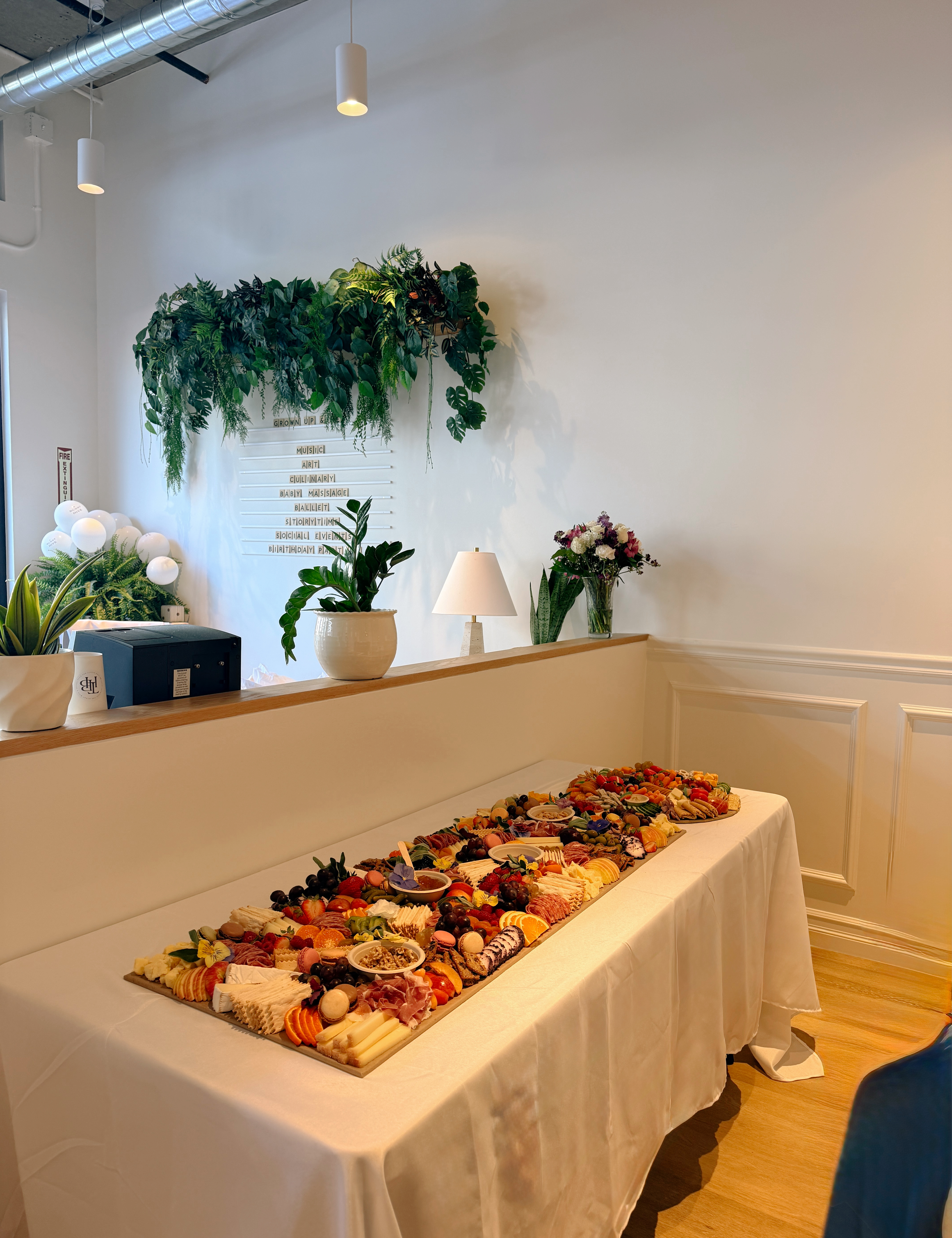 Outdoor charcuterie picnic setup with fruits and meats