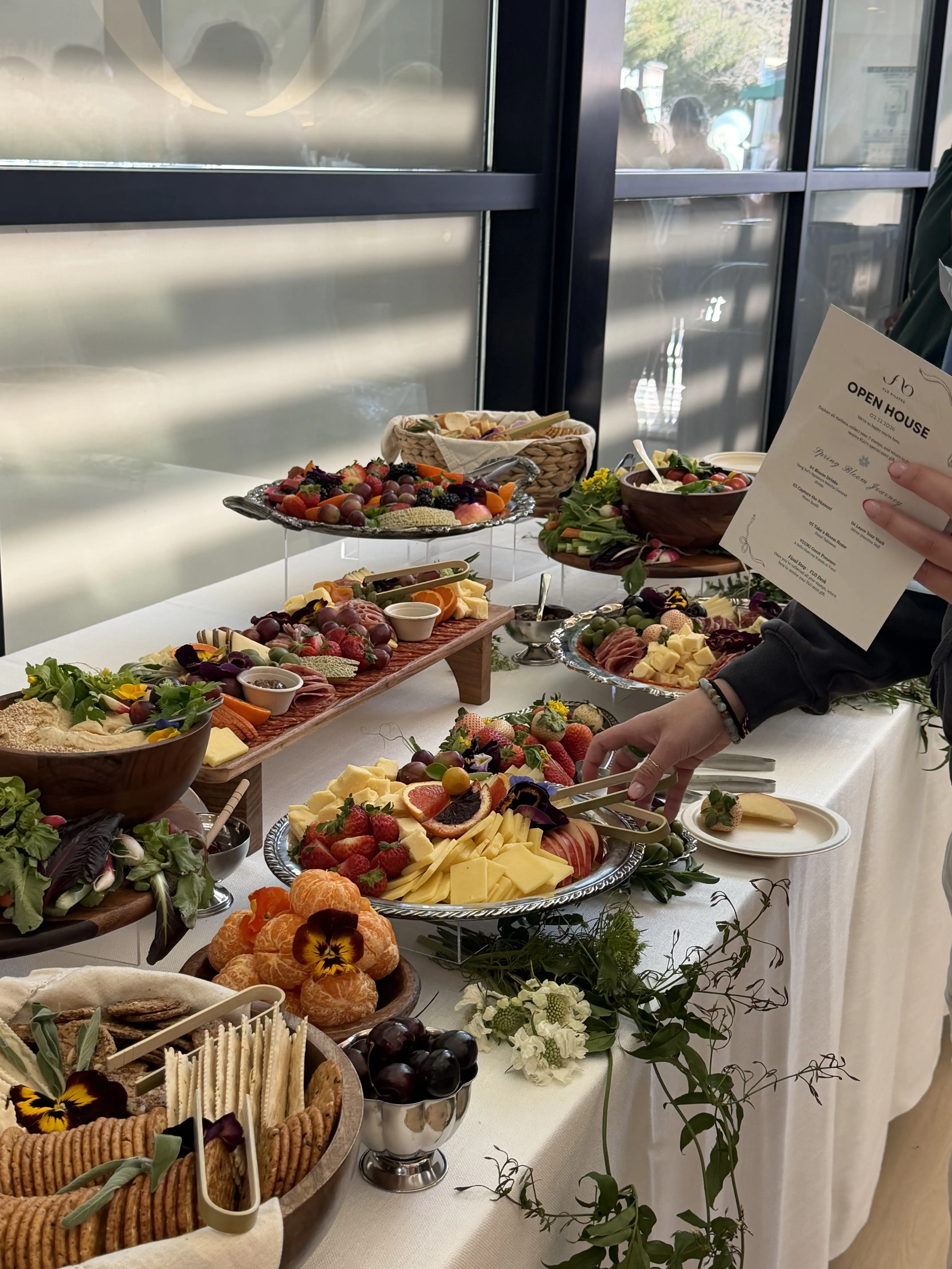 Outdoor charcuterie picnic setup with fruits and meats