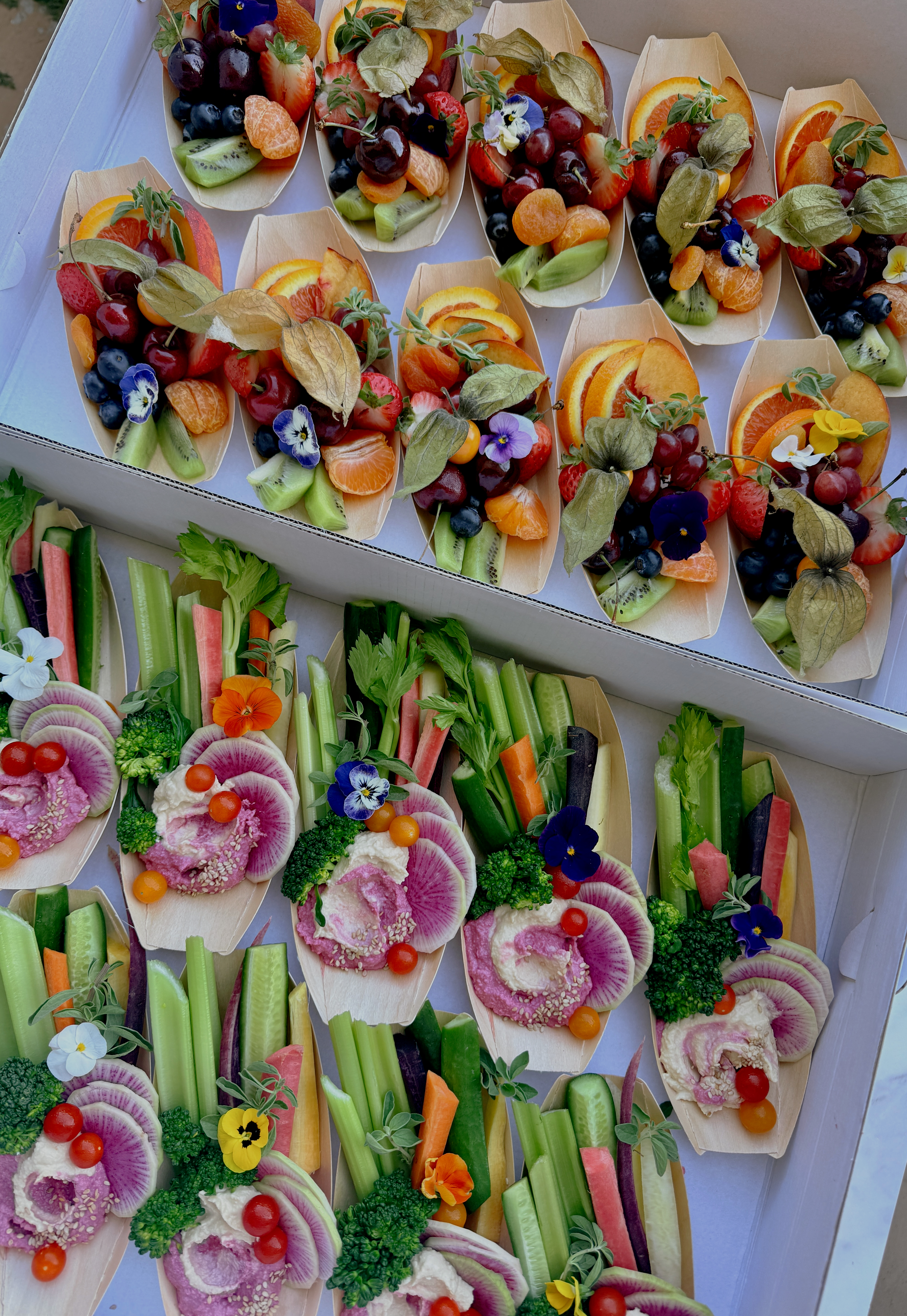 Outdoor charcuterie picnic setup with fruits and meats